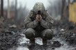 © Andrei - Soldier kneels in muddy battlefield praying, expressing deep emotions during a volatile moment in combat.