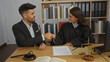 © Krakenimages.com - Man and woman in professional attire shaking hands in an office setting with legal documents and a gavel on the desk.