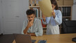© Krakenimages.com - Man thinking while woman arranges documents in modern office setting, showcasing a typical business workplace environment with professional interaction.