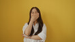 © Krakenimages.com - Woman laughing with hand over mouth isolated against yellow background, showcasing beauty, youth, and joy with an asian cultural touch in a bright, cheerful setting