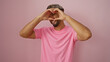 © Krakenimages.com - Young muslim man making a heart shape with hands over isolated pink background showcasing a joyful and positive vibe
