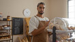 © Krakenimages.com - Young man taking notes in a bakery surrounded by baked goods and pastries