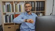 © Krakenimages.com - Young man with beard smiling in an office interior with shelves full of books and binders, checking his wristwatch