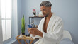 © Krakenimages.com - Handsome young man with beard relaxing in a spa salon while using his smartphone indoors