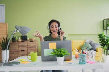 Photo of lovely young girl excited call center operator dressed green garment house freelancer home office indoors room