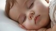 © Studicon - A baby is sleeping on a white pillow