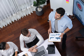 Fototapete - Top view analyst team utilizing BI Fintech to analyze financial data at table in meeting room. Analytic BI dashboard power on paper for business insight and strategic marketing planning. Prudent