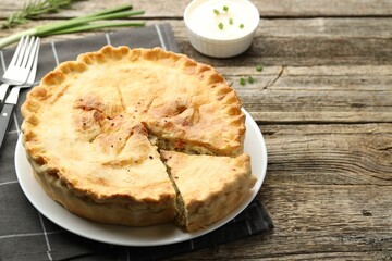 Canvas Print - Delicious fresh homemade pie served on wooden table, closeup. Space for text