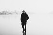 © T.Den_Team - Silhouette of alone man standing on winter fog and ice background. Concept of psychology, guy thinking about something