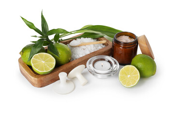 Wall Mural - Spa composition with limes, massage stones, burning candle, sea salt and green leaves isolated on white