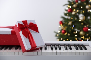 Wall Mural - Synthesizer with gift boxes near Christmas tree indoors, closeup