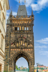 Wall Mural - Old Town Bridge Tower at the beginning of the Charles Bridge and with Prague caste on the background, Prague, Czech Republic.