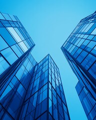 Canvas Print - Upward view of modern glass skyscrapers against a clear sky