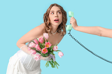 Wall Mural - Young woman holding bouquet of beautiful tulips and hand with retro telephone on blue background. International Women's Day