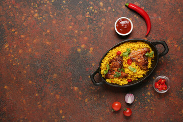 Canvas Print - Baking dish of traditional chicken biryani with ingredients on grunge background