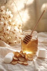 Wall Mural - A minimalistic flat lay composition featuring a jar of honey with a wooden dipper, sugar cubes, and dried flower petals on a soft fabric background