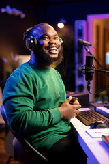 Aufkleber - Portrait of african american producer musician recording new soundtracks in studio, using a microphone and headset to produce cool music. Young artist composer singing his new track.