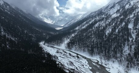 Sticker - Aerial footage of beautiful high altitude snowcapped mountains and forest landscape