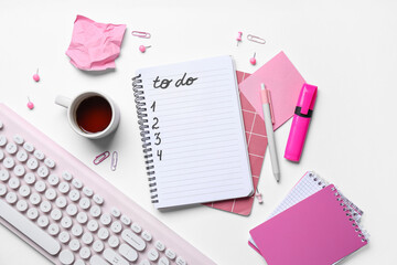 Wall Mural - Notebook with blank to do list, cup of tea, stationery and keyboard on white background. Top view