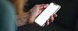 © Prayoon - Female hand holding a cell phone with a blank screen, fingers wrapped around the device, palm facing upwards, closeup, blank screen, handhold