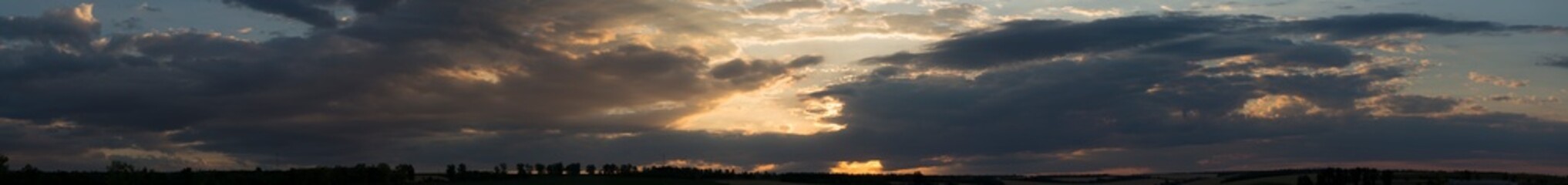 Wall Mural - Landscape at sunset. Tragic gloomy sky. Panorama. Crimson twilight. Heavy, gloomy, dark clouds.