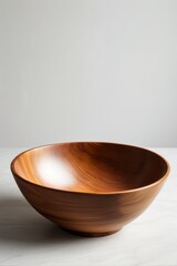 Wall Mural - there is a wooden bowl sitting on a table with a white wall