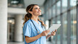 © Andesgn - Happy woman or doctor face in busy hospital with tablet for healthcare services, leadership and career mindset. Portrait of medical professional or female on telehealth app for clinic job management
