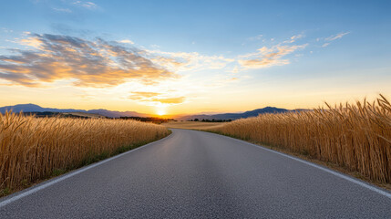 Sticker - scenic road winding through golden wheat fields at sunset