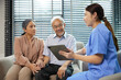 © offsuperphoto - nurse or caregiver meeting and talking with about health with senior couple