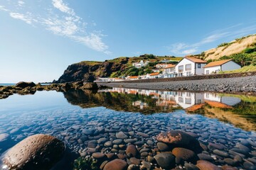 Poster - Coastal Reflection Village houses mirrored in a rocky tide pool on bright day