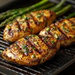 © Murad - Grilled Chicken Breasts with Asparagus: A Delicious and Healthy Meal Ready to Serve on a Black Grill Pan, Cooked to Perfection with a Sprinkling of Fresh Herbs