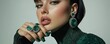 © Georgii - Elegant woman adorned with emerald jewelry and green fashion ensemble