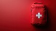© Vancouver - Red first aid kit bag with white cross on solid red background