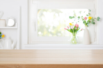 Wall Mural - empty wooden table top with free space on blurred decorated with colorful spring flowers window back