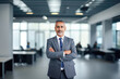 © Aqsapics - indian middle age businessman standing confidently