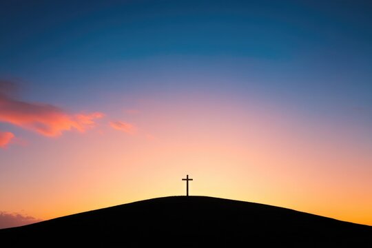 Silhouette of cross against vibrant sunset, symbolizing hope and