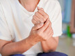 © Яe Life Яe World - Lifestyle health concept. Asian woman holding her wrist, which is inflamed and painful. Elderly people with arthritis, wrist pain, joint pain and elbow . Osteoarthritis due to hard work and old age.
