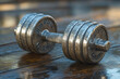 © Tanu - Weight training equipment rests on a wooden surface after an intense workout session at a local gym in the morning