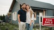 © VAKSMANV - Cute Caucasian couple standing in front of new building with green lawn. Proud about purchasing first property. Happy people looking at camera. Smiling with joy. Husband hugging beloved wife.