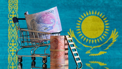 Banknotes in denominations of 5,000 and 10,000 Kazakhstan tenge of a new design against the background of the flag of the Republic of Kazakhstan