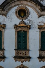 Wall Mural - Ornate historical building facade with green shutters.