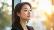© wpw - Sunlit portrait of a smiling woman gazing thoughtfully out of a window.