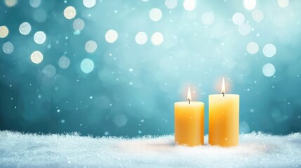 Wall Mural - Two candles are lit on a snowy surface. The candles are yellow and are placed on top of the snow