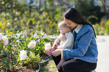 Wall Mural - Loving mother with baby in floral park