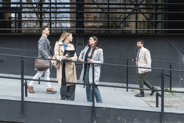 Wall Mural - Professional occupation, office workers. Business people meet before staff meeting and presentation in office building, to talk and discus plans and tactic of speech theme. Finance and economy.