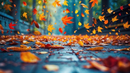 Poster - Colorful autumn leaves falling on a path in a park with blurred trees in the background and copy space for text