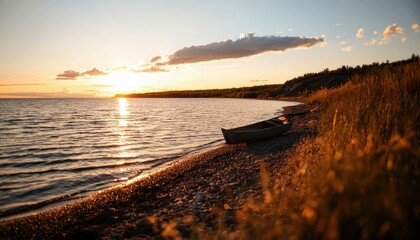 Wall Mural - Boat on pebble beach at sunset by calm water, tranquil scene, scenic landscape