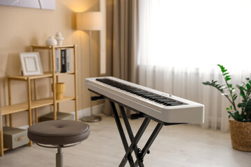 Wall Mural - Synthesizer and stool indoors. Electronic musical instrument