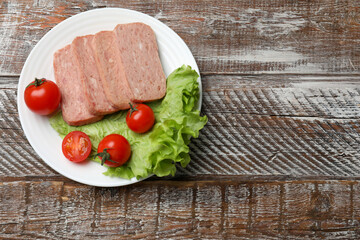 Wall Mural - Tasty canned meat, tomatoes and lettuce on wooden table, top view. Space for text