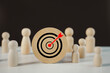 © Dontree - Target icons on wooden round cubes stand on the center on the team. Business achievement goal and objective target. Set up business objective target goal concept. Challenge and opportunity concept.